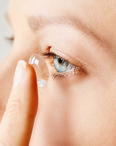 Contact lens being applied to eye